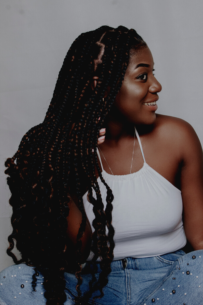 Portrait of a Smiling Woman with Black Hair in Dreadlocks